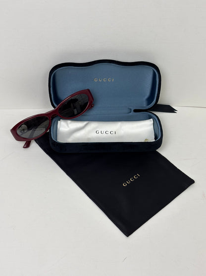 Gucci sunglasses with case and box on a white background