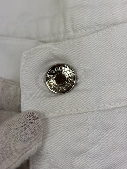 Close-up of a white denim button with a brand logo on a white background